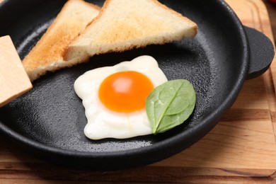 Photo of Sweet gummy fried egg and bread served as breakfast on wooden board, closeup. April Fools' Day