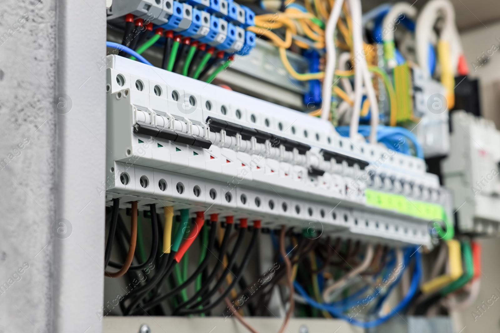 Photo of Electrical panel with many wires in fuse box, closeup