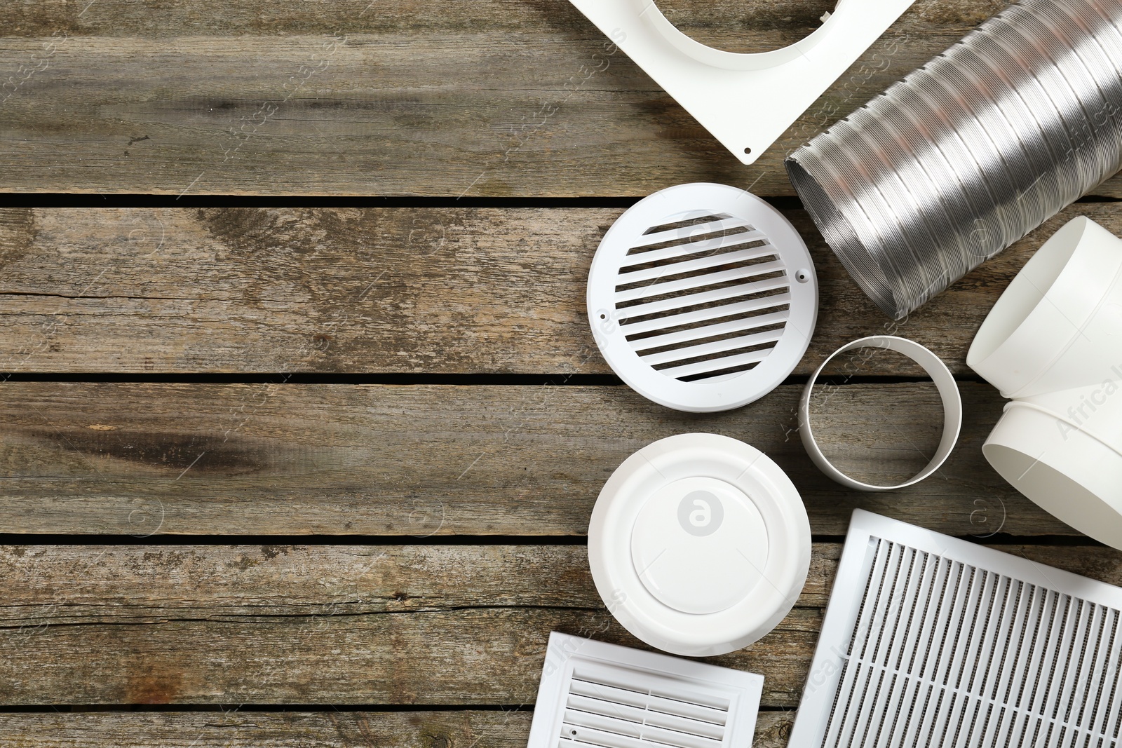 Photo of Parts of home ventilation system on wooden surface, flat lay. Space for text