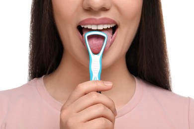 Woman brushing her tongue with cleaner on white background, closeup