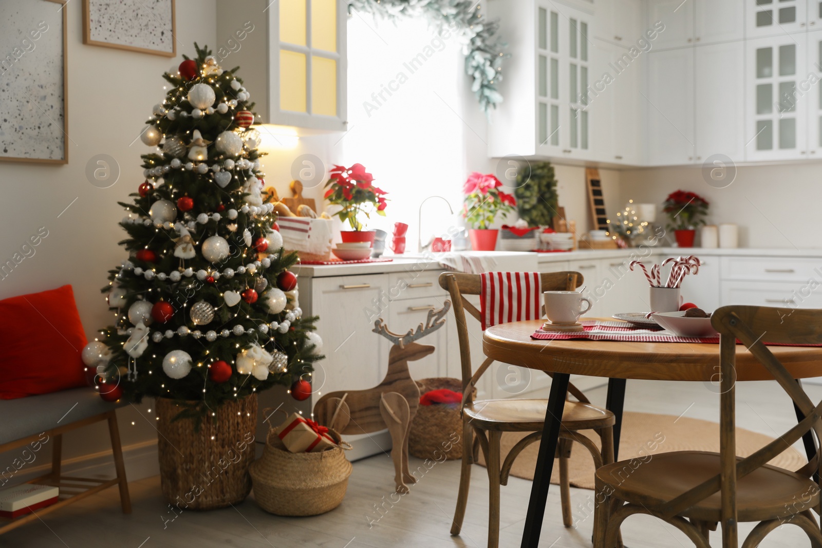 Photo of Beautiful kitchen interior with Christmas tree and festive decor