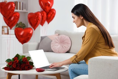Photo of Valentine's day celebration in long distance relationship. Woman chatting with her boyfriend at home