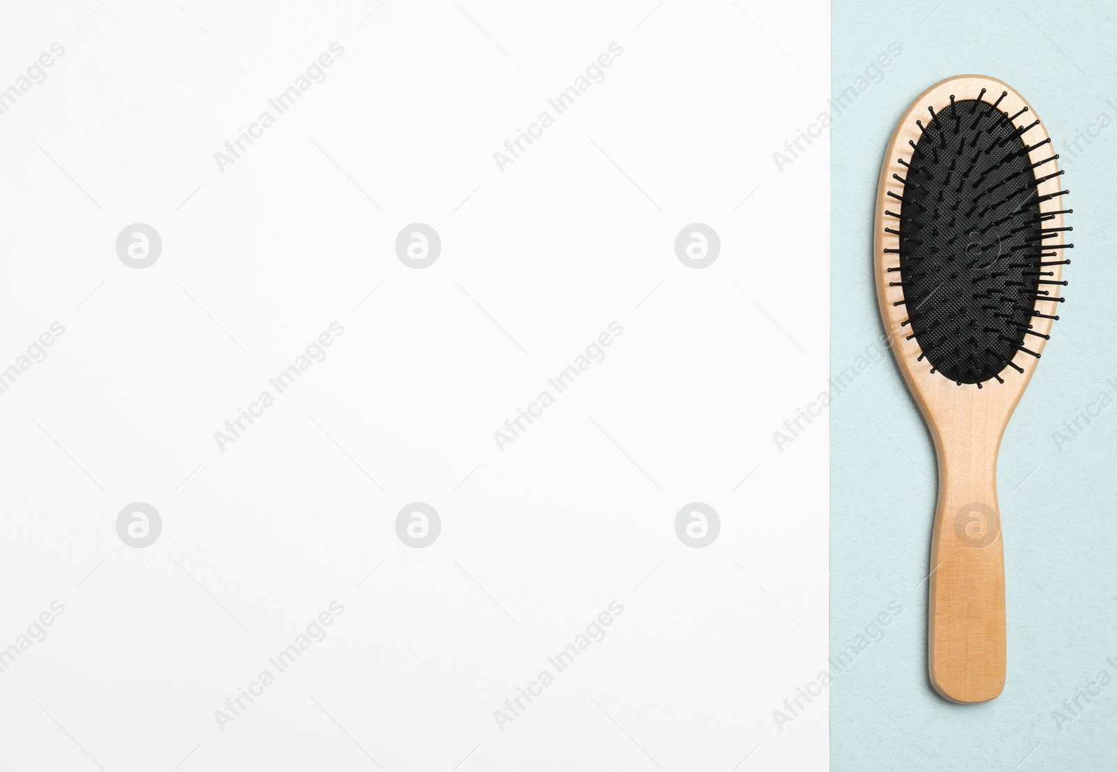 Photo of Modern hair brush on color background, top view. Space for text