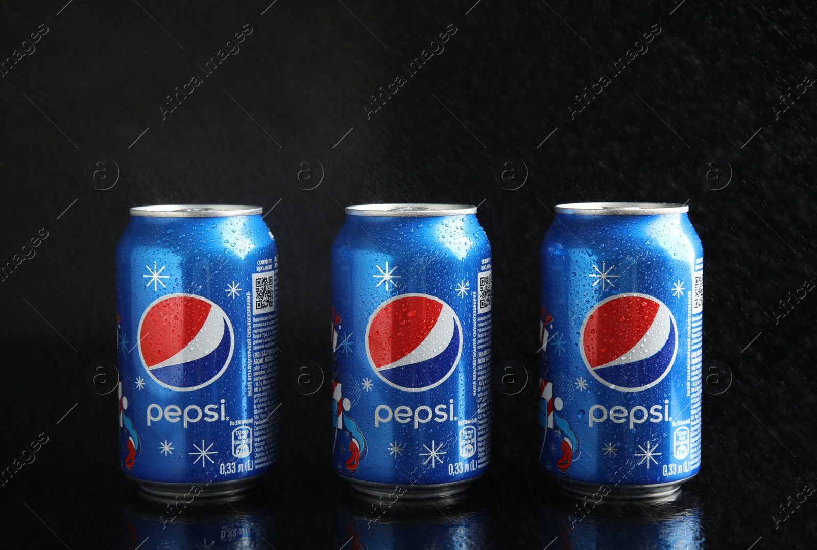 Photo of MYKOLAIV, UKRAINE - FEBRUARY 9, 2021: Cans of Pepsi on black background