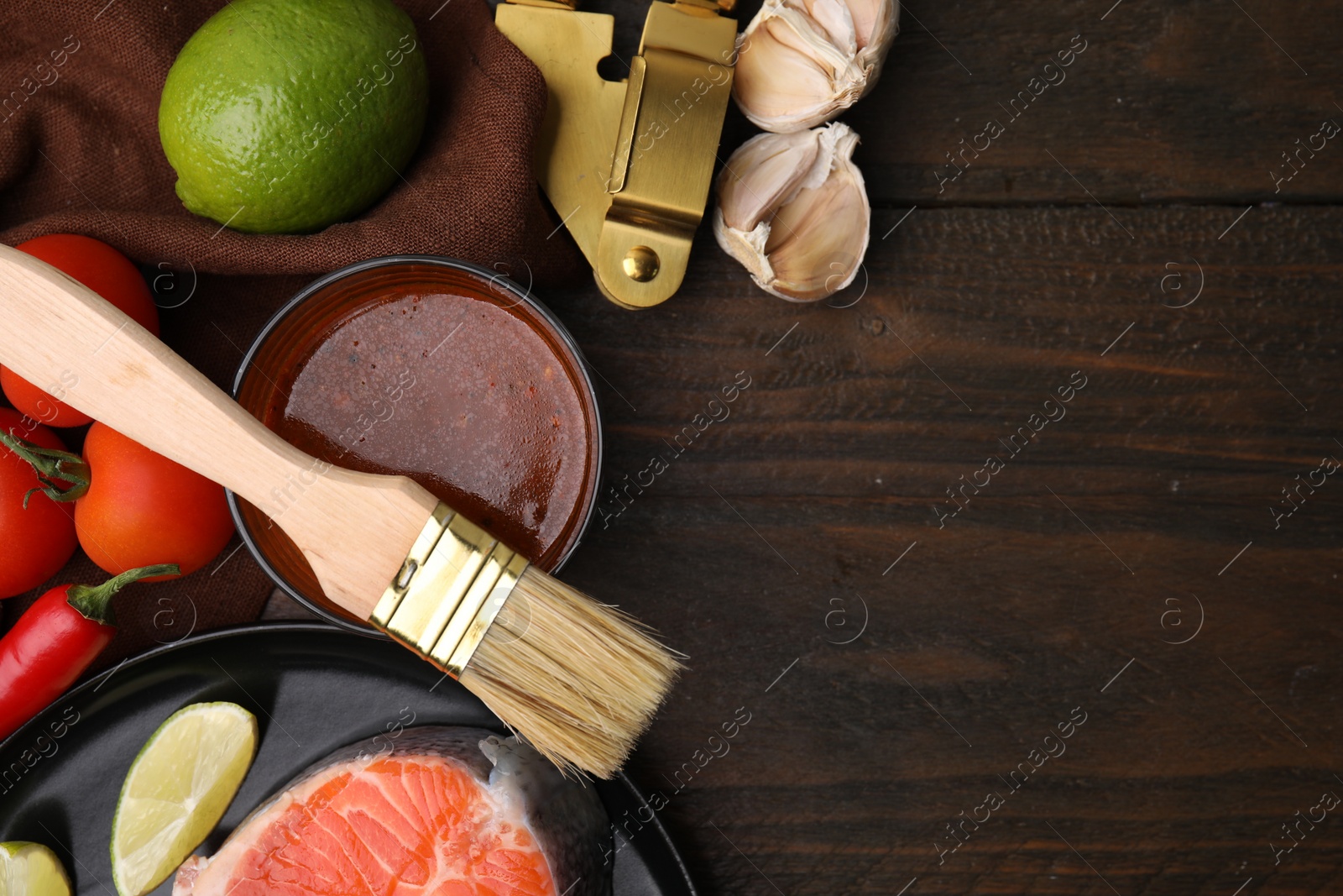 Photo of Tasty fish marinade and products on wooden table, flat lay. Space for text