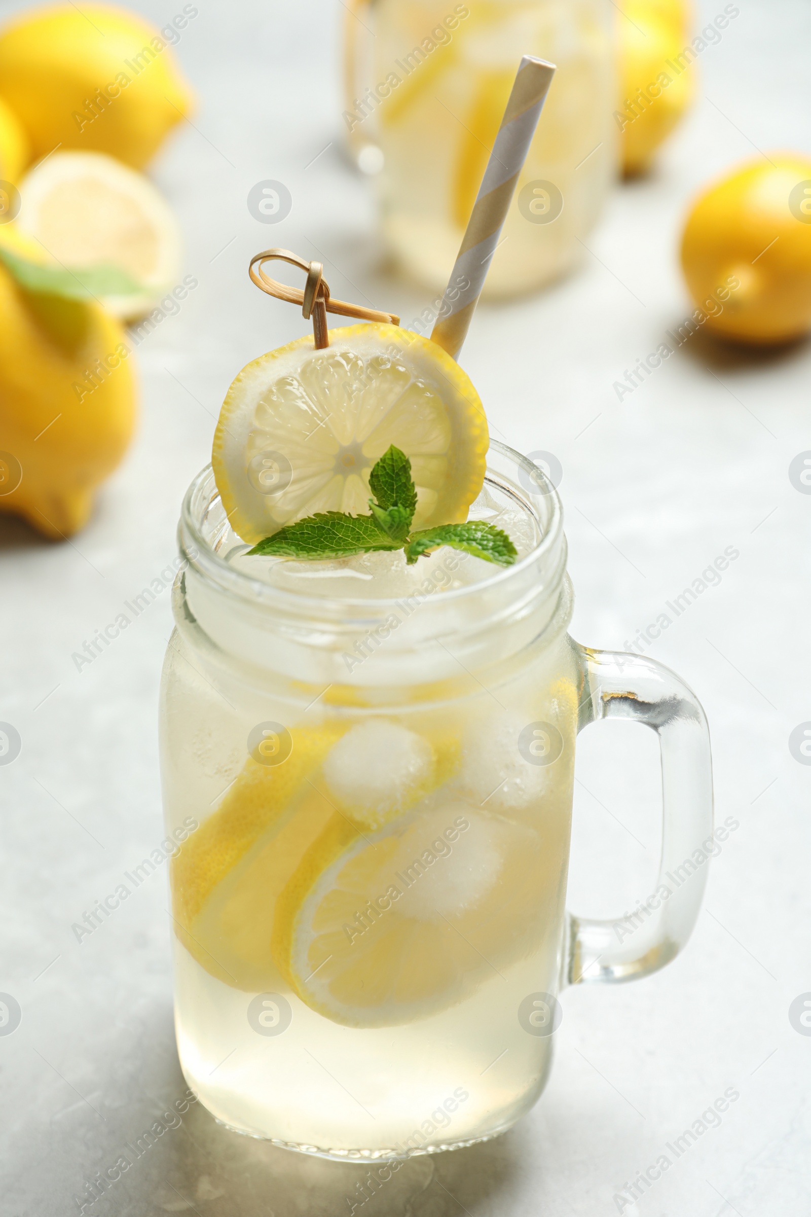 Photo of Natural lemonade with mint on light grey marble table. Summer refreshing drink