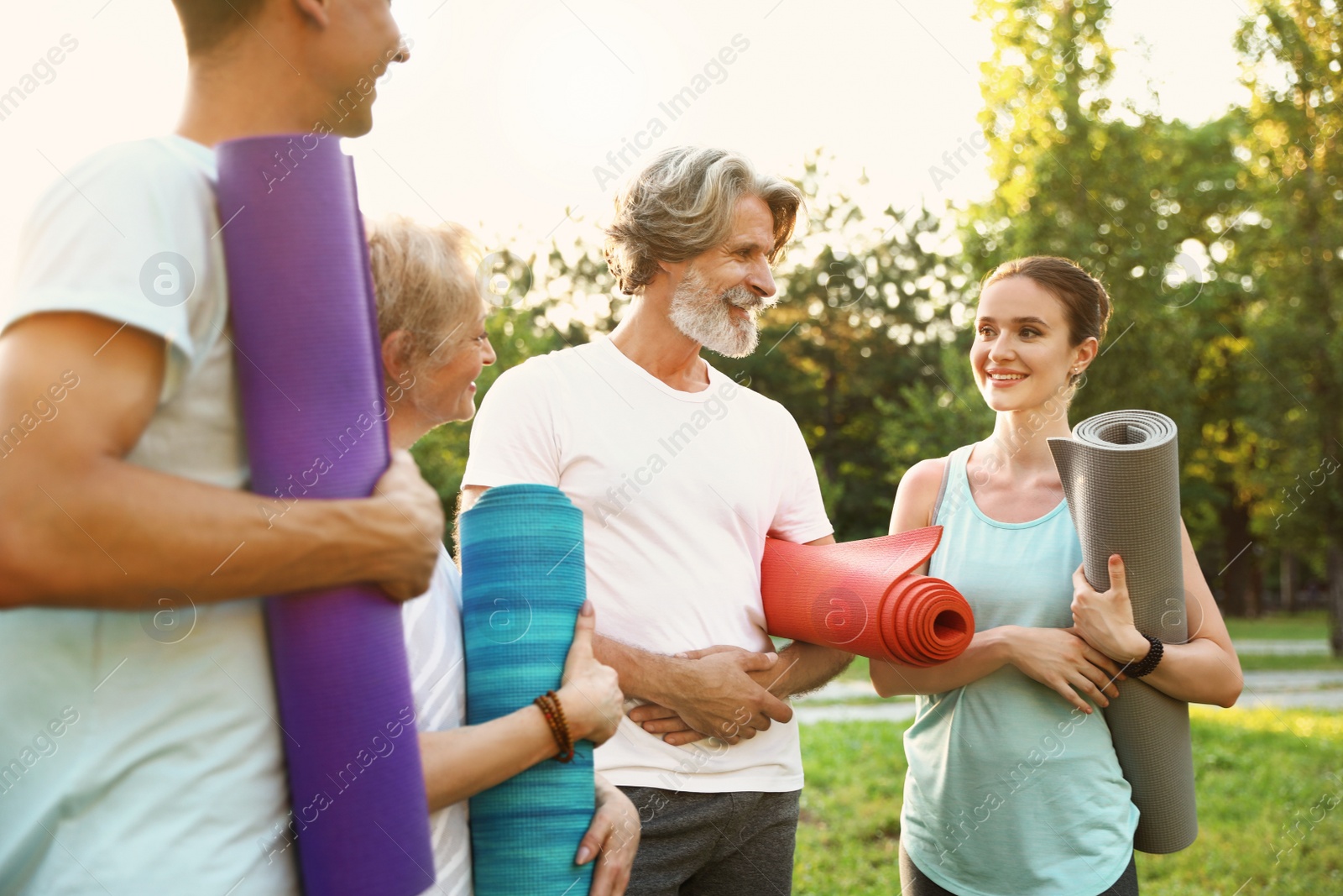 Photo of Group of people before morning yoga practice in park