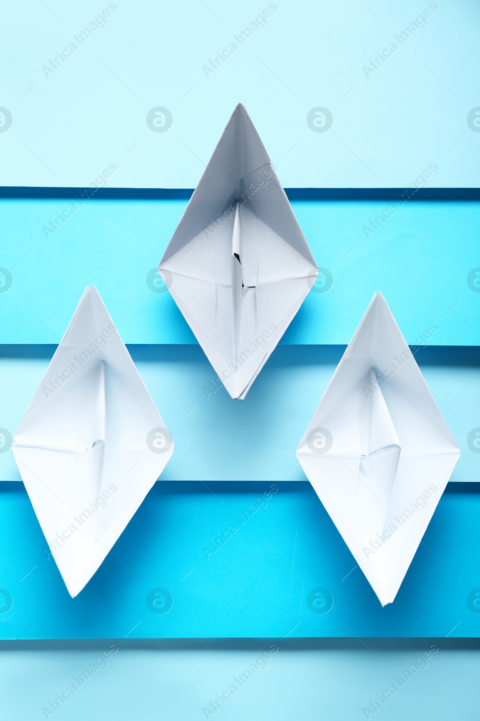 Photo of Competition concept. Paper boats on colorful background, flat lay