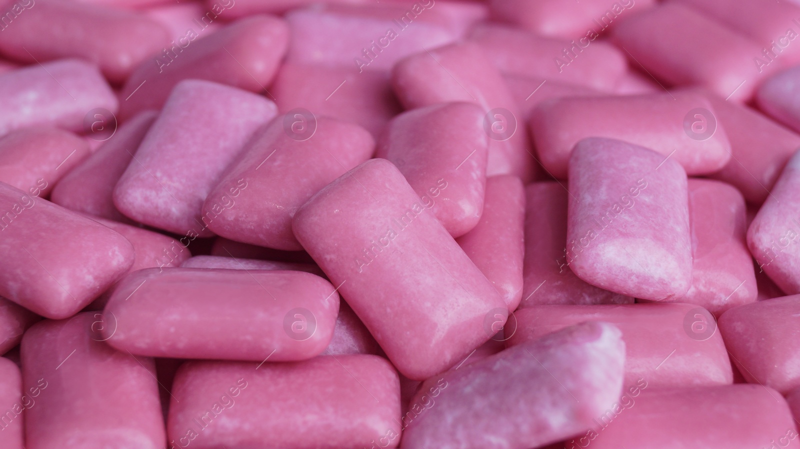 Photo of Many pink chewing gums as background, closeup