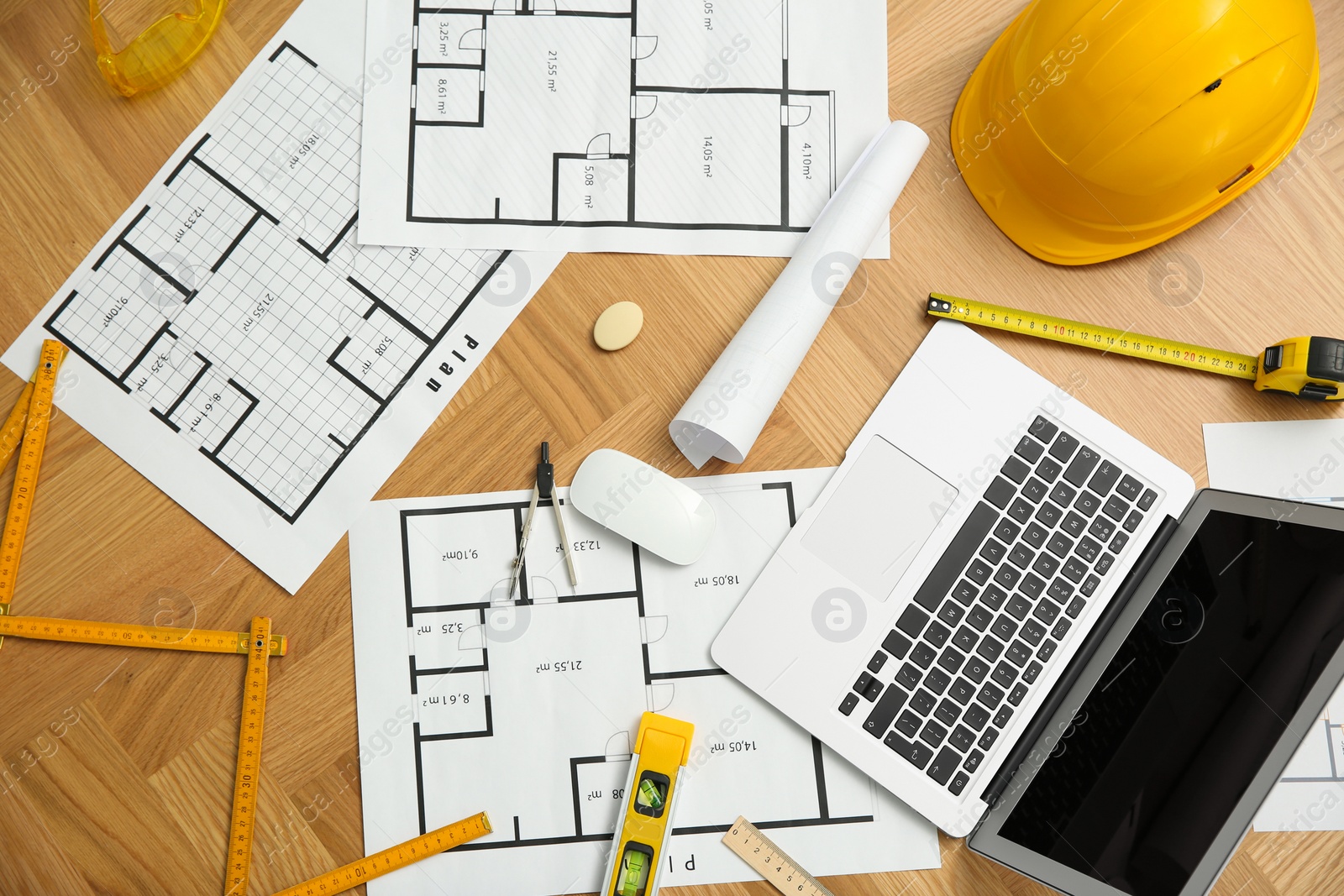 Photo of Construction drawings, laptop and tools on wooden table, flat lay