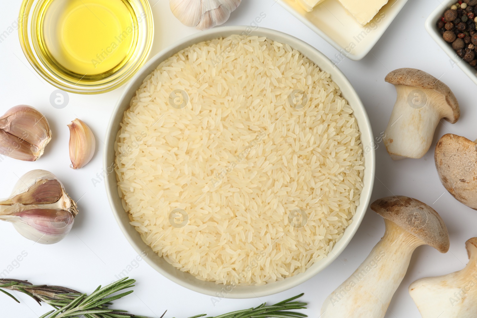 Photo of Different ingredients on white background, top view. Risotto recipe