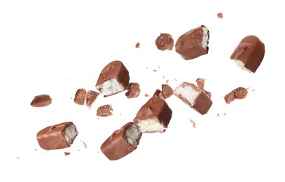 Image of Pieces of delicious chocolate bars with coconut filling falling on white background