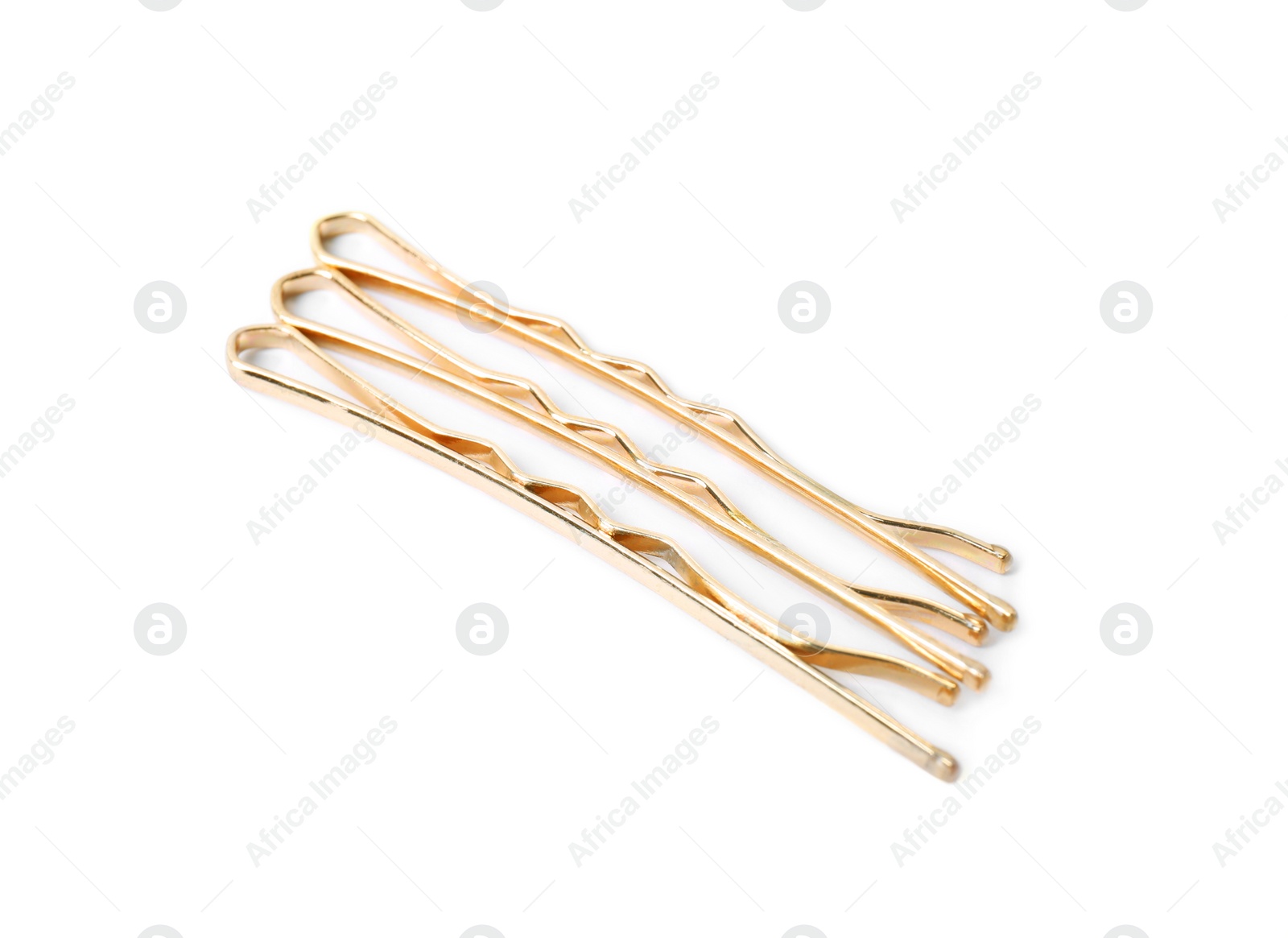 Photo of Many gold hair pins on white background