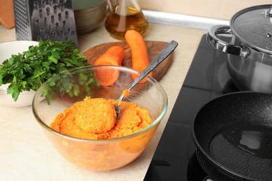 Photo of Preparing vegan cutlets. Bowl with carrot mixture on countertop