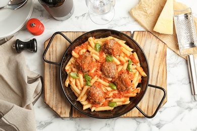 Photo of Pasta with meatballs and tomato sauce on light background