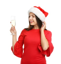 Photo of Young beautiful woman in Santa hat holding glass of champagne on white background. Christmas celebration