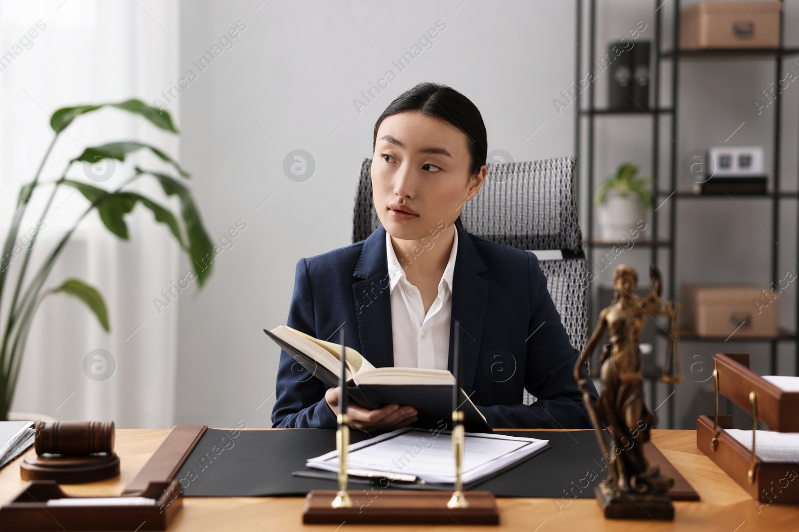 Photo of Notary with book at table in office