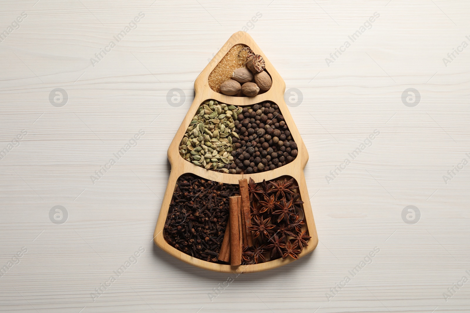 Photo of Different spices and nuts on white wooden table, top view