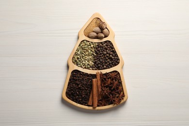 Photo of Different spices and nuts on white wooden table, top view