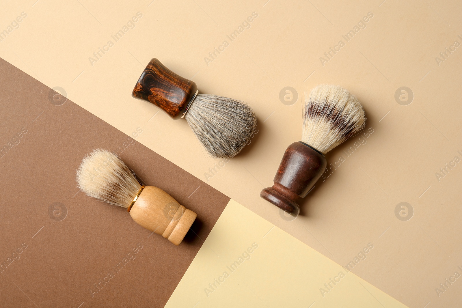 Photo of Flat lay composition with shaving brushes for men on color background