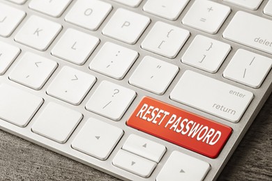 Image of Red button with text RESET PASSWORD on keyboard, closeup view