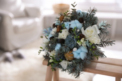 Photo of Beautiful wedding winter bouquet on wooden rack indoors. Space for text