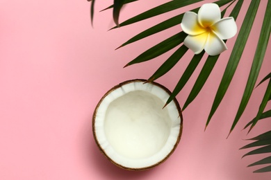 Flat lay composition with fresh coconut half on pink background