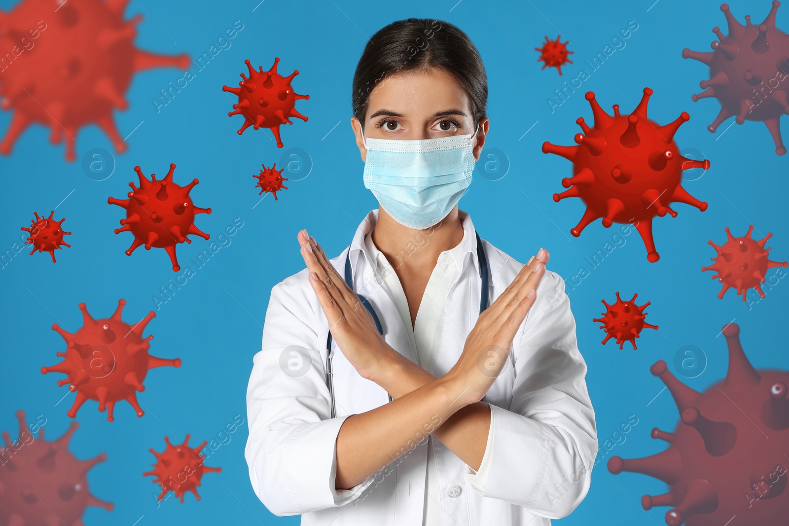 Image of Stop Covid-19 outbreak. Doctor wearing medical mask surrounded by virus on blue background