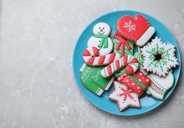 Photo of Delicious Christmas cookies on light marble table, top view. Space for text