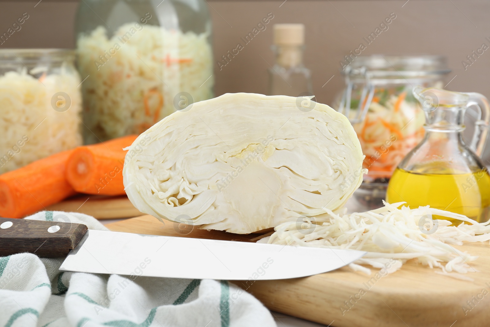 Photo of Cooking delicious sauerkraut soup. Fresh chopped cabbage and ingredients on table, closeup