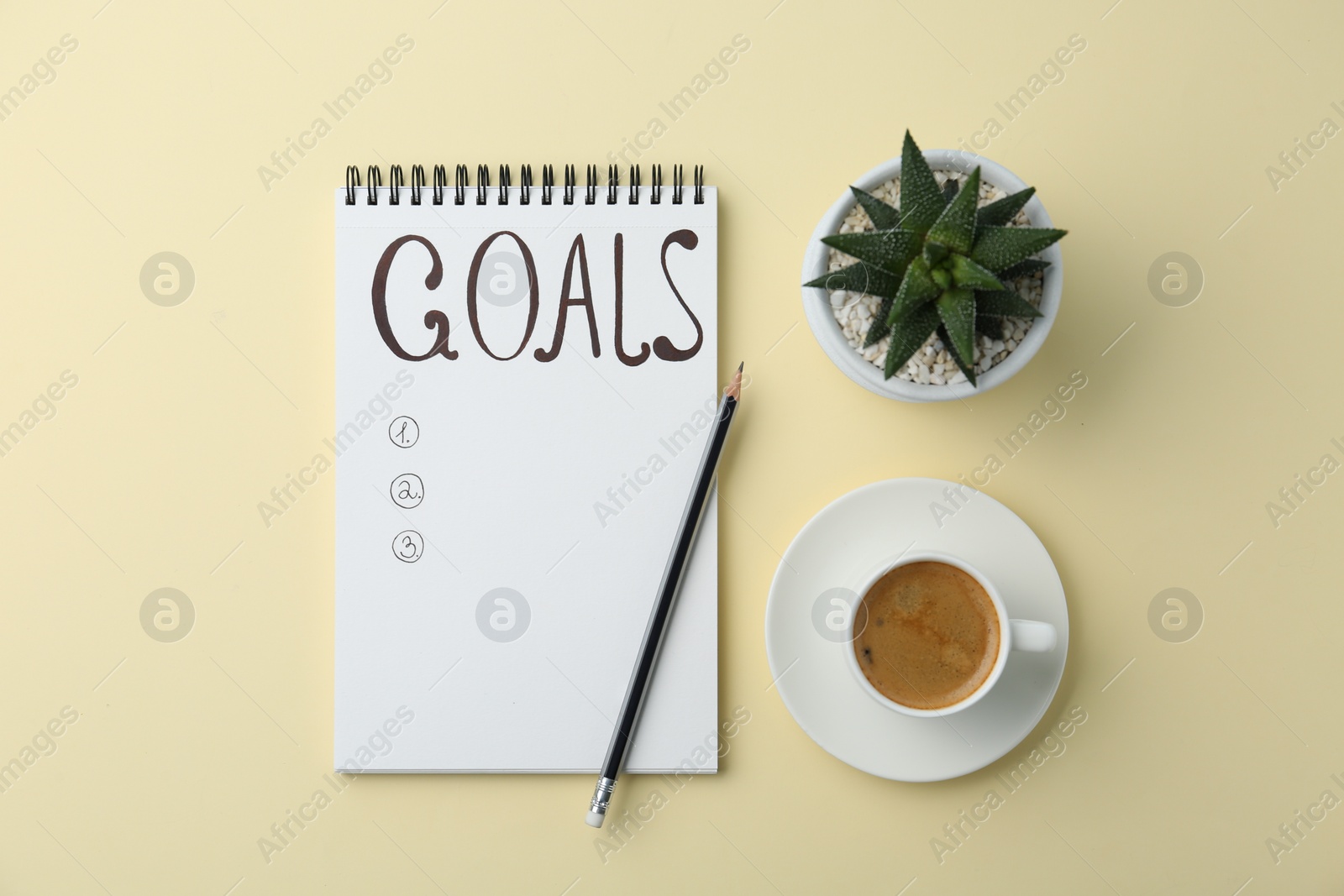 Photo of Planning concept. Empty list of goals in notebook and coffee on beige background, flat lay