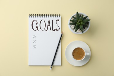 Photo of Planning concept. Empty list of goals in notebook and coffee on beige background, flat lay