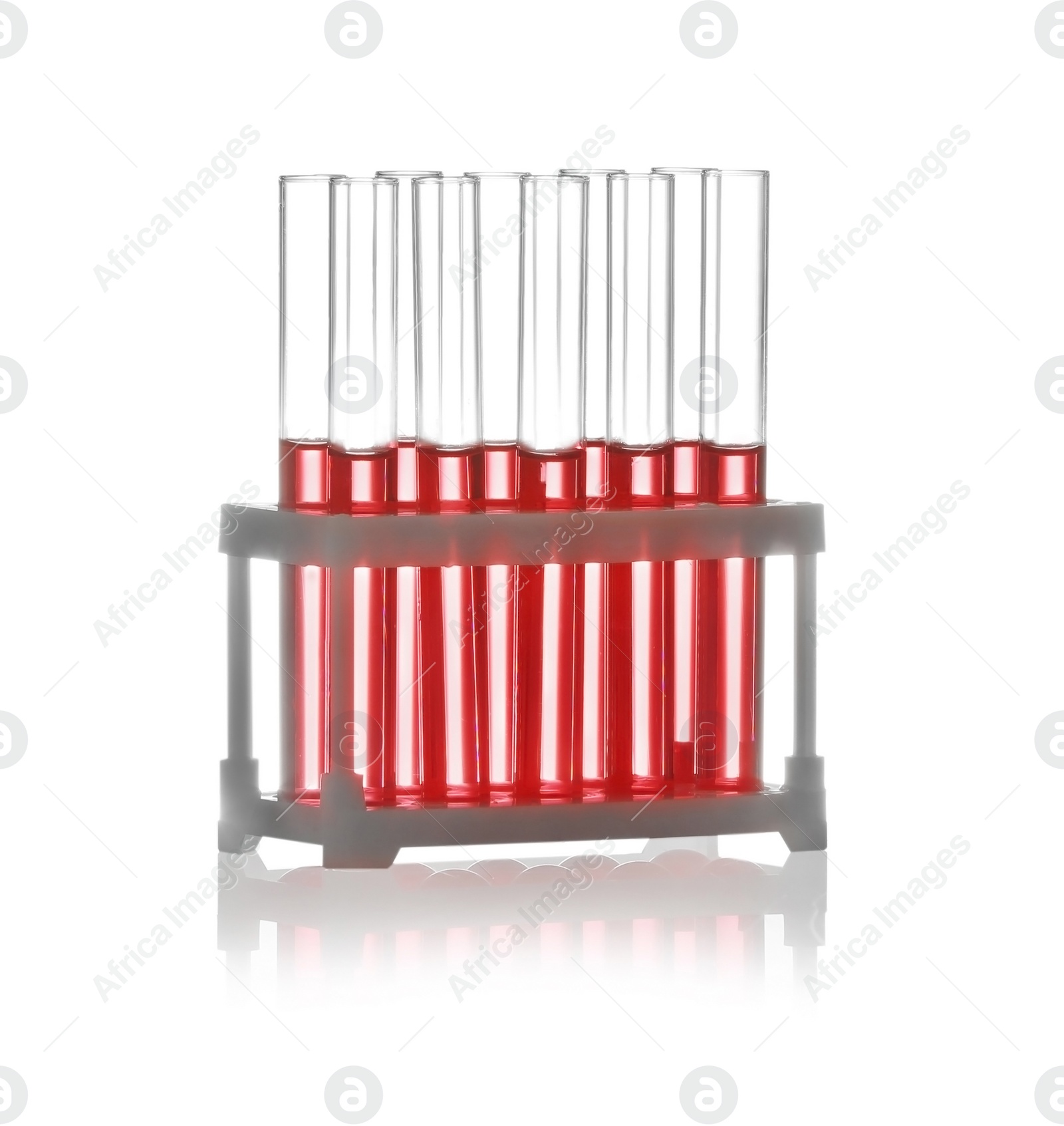 Photo of Test tubes with liquid samples in rack on white background. Chemistry glassware