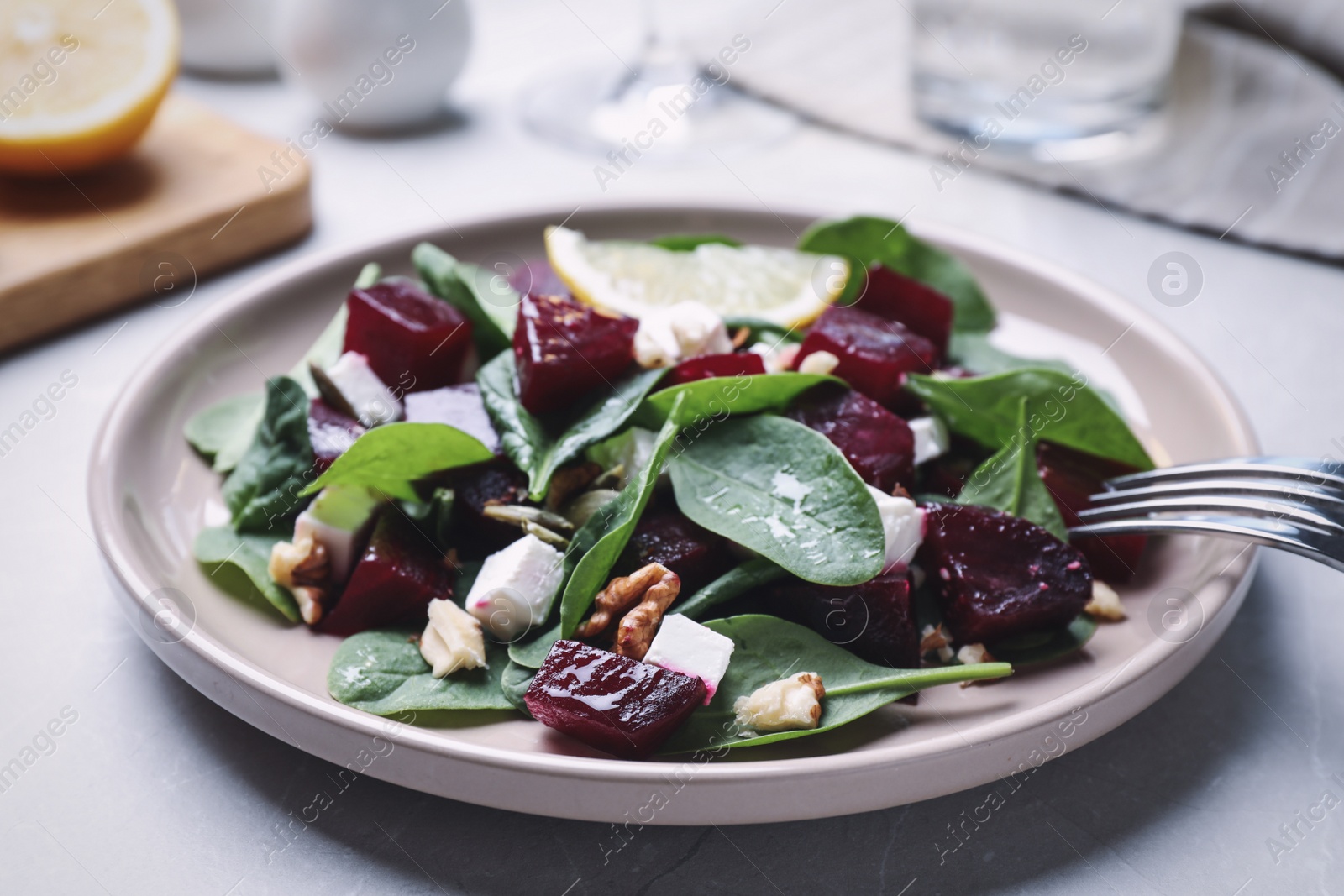 Photo of Delicious beet salad served on grey table, closeup