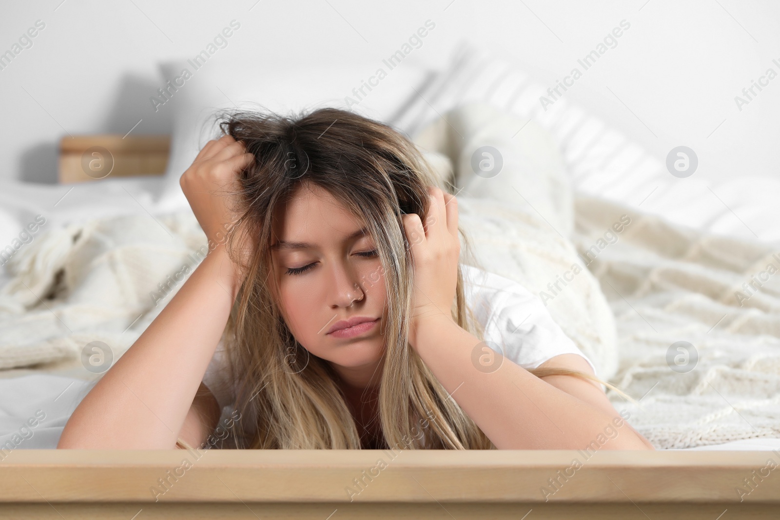 Photo of Sleepy young woman in bed at home