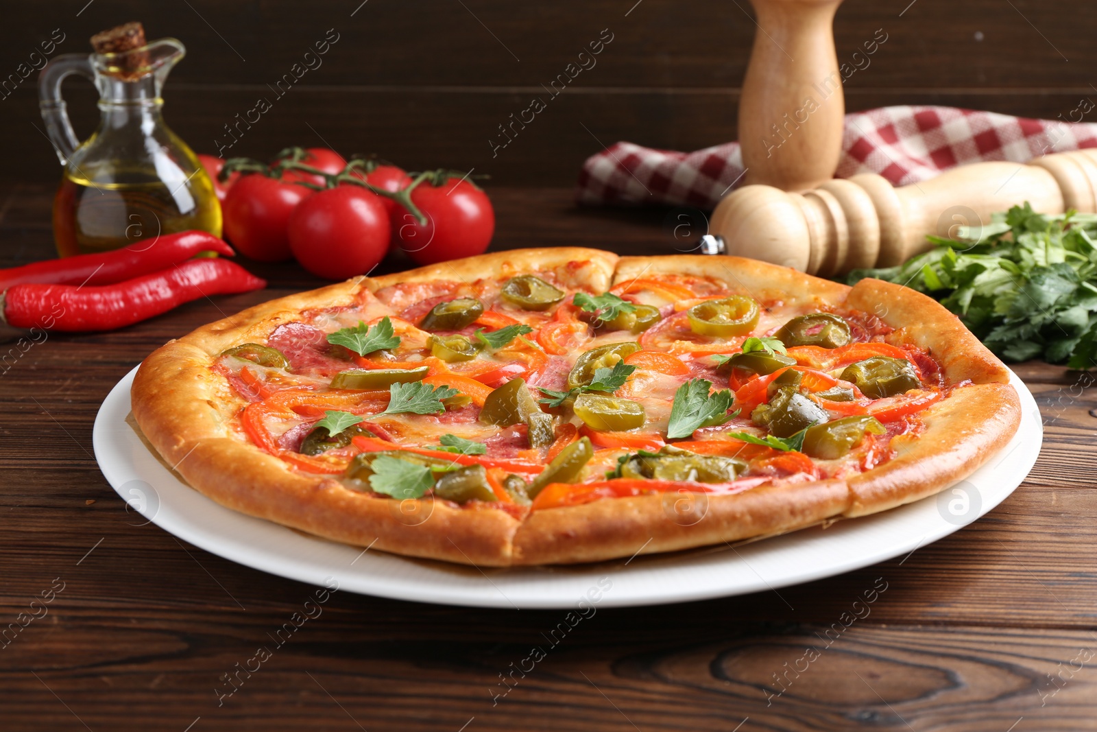 Photo of Delicious pizza Diablo and ingredients on wooden table