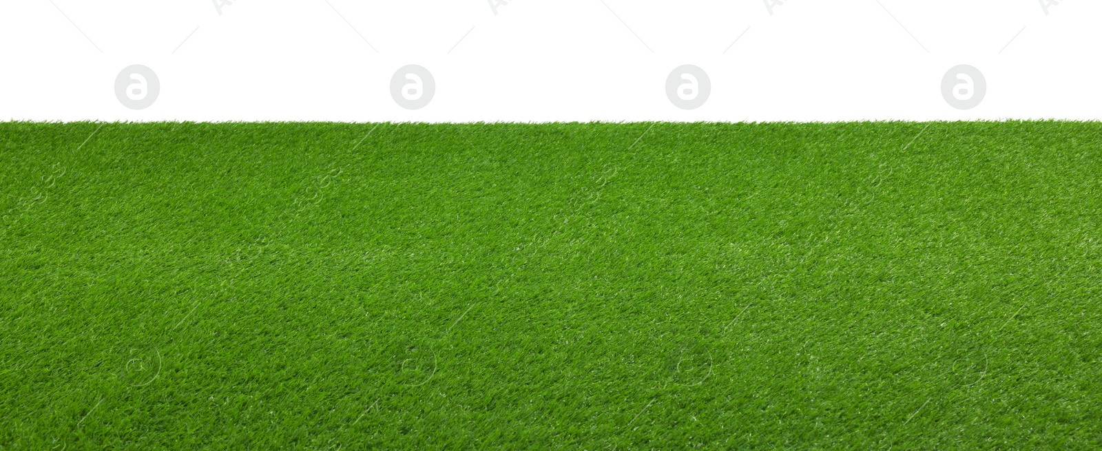 Photo of Green artificial grass surface isolated on white