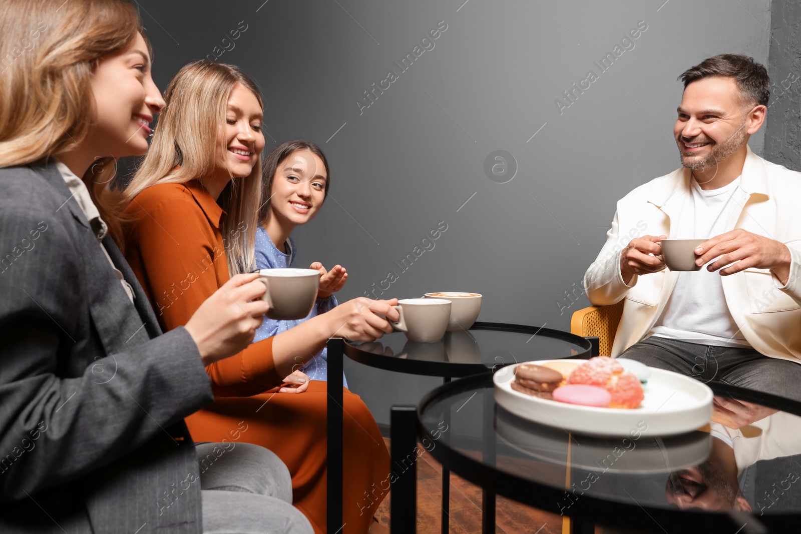 Photo of People with coffee spending time together in cafe