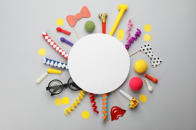 Photo of Flat lay composition with carnival items and blank card on light grey background. Space for text