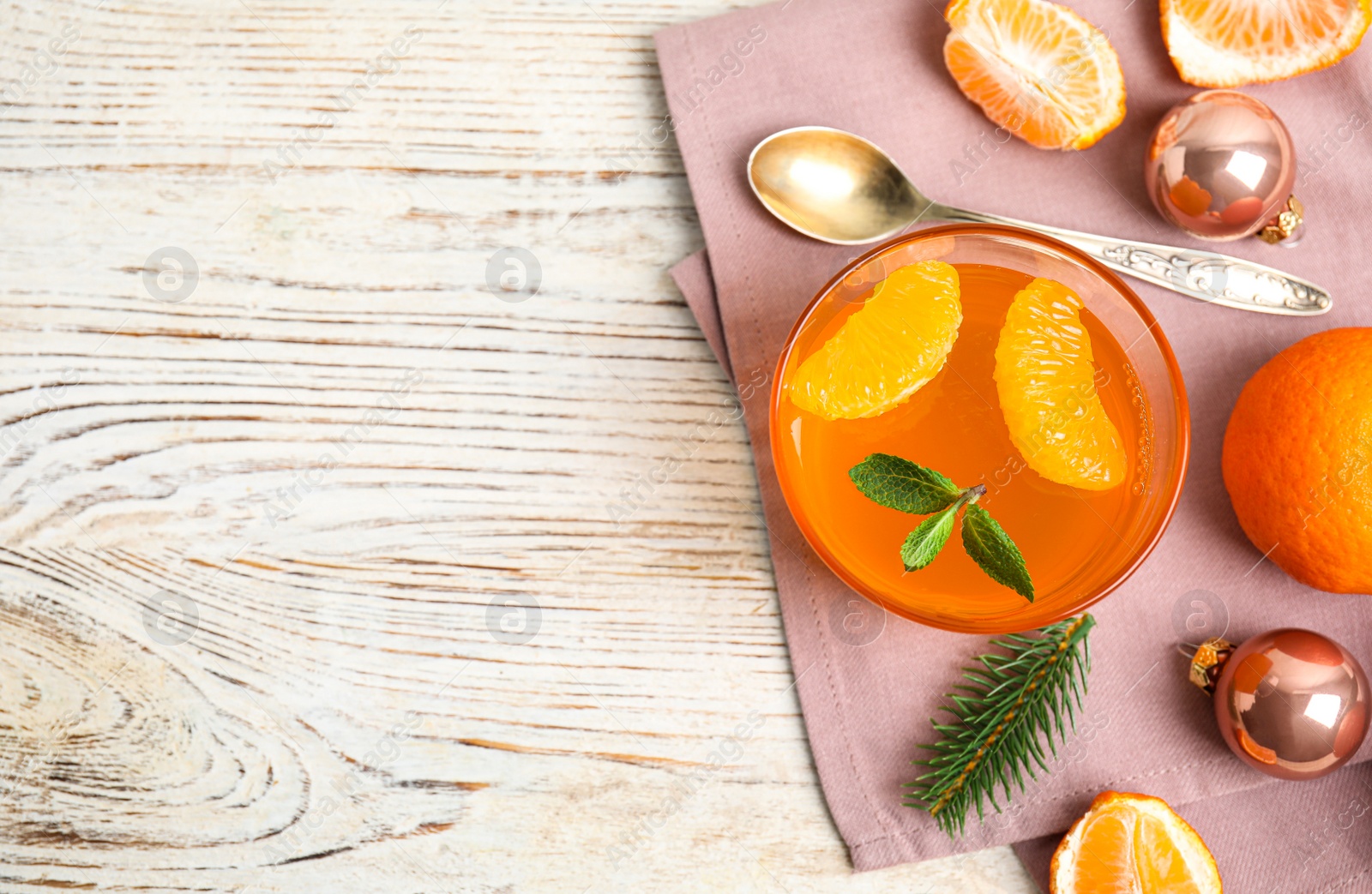 Photo of Delicious tangerine jelly on white wooden table, flat lay. Space for text