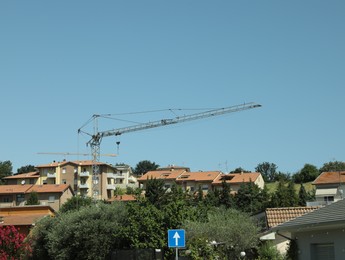 Cityscape with buildings and tower crane on sunny day