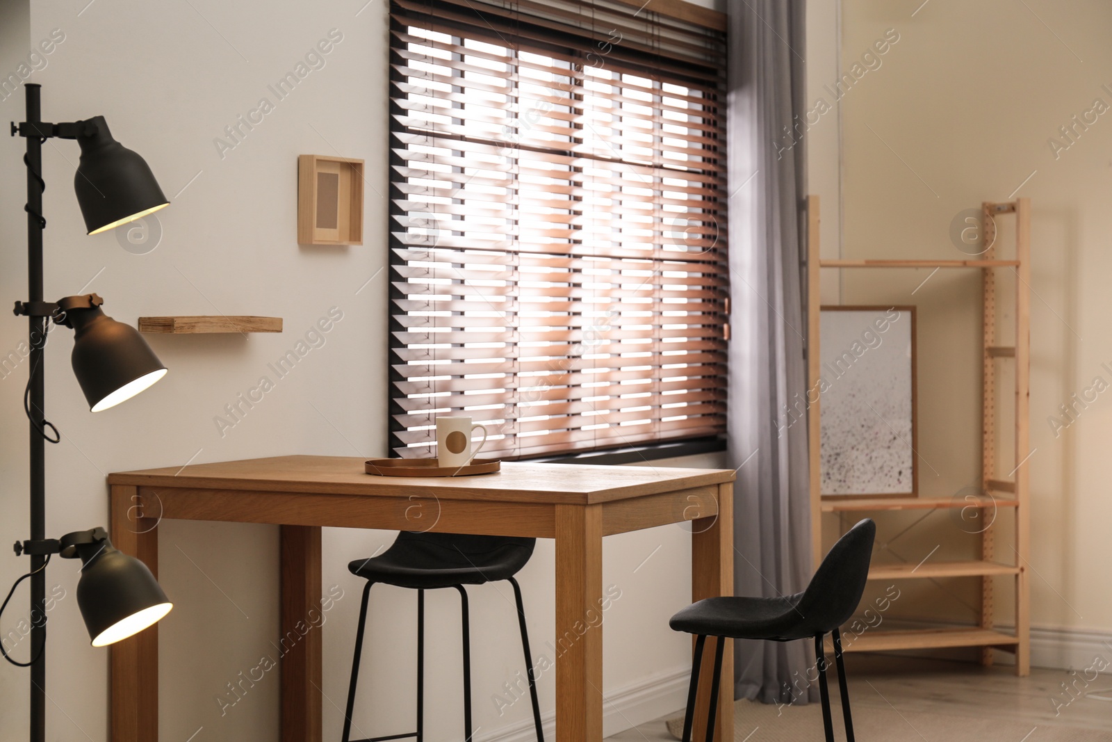 Photo of Modern room interior with table set, window blinds and stylish decor elements
