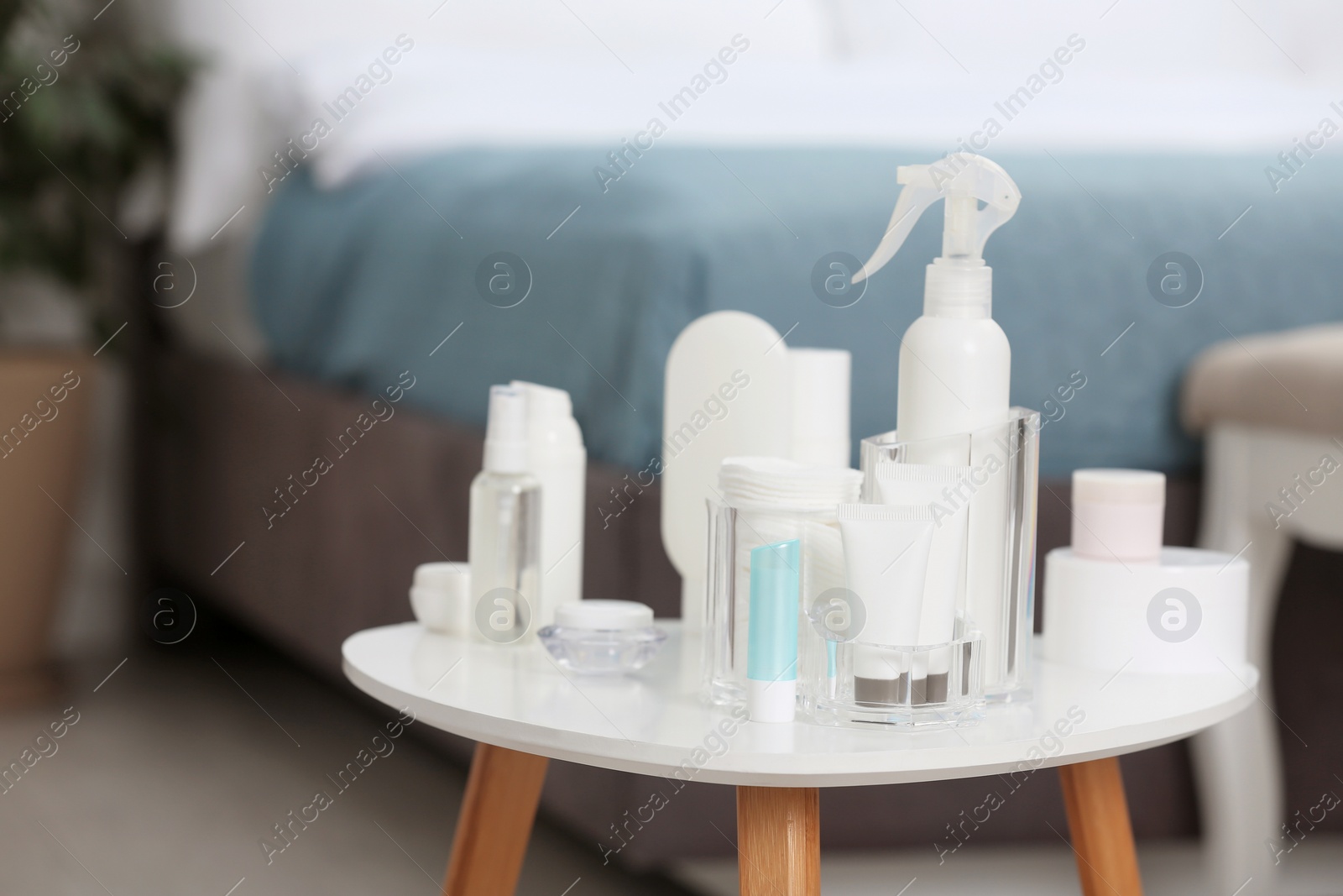 Photo of Set of cosmetic products on table against blurred background. Space for text