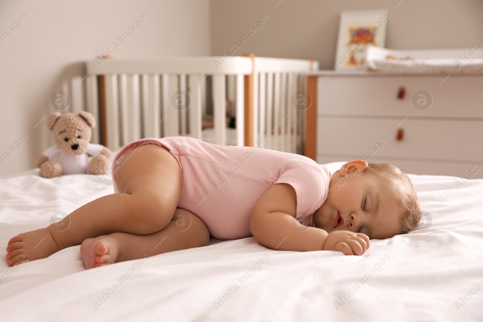 Photo of Adorable little baby sleeping on bed at home