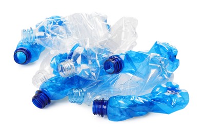 Photo of Crumpled disposable plastic bottles on white background