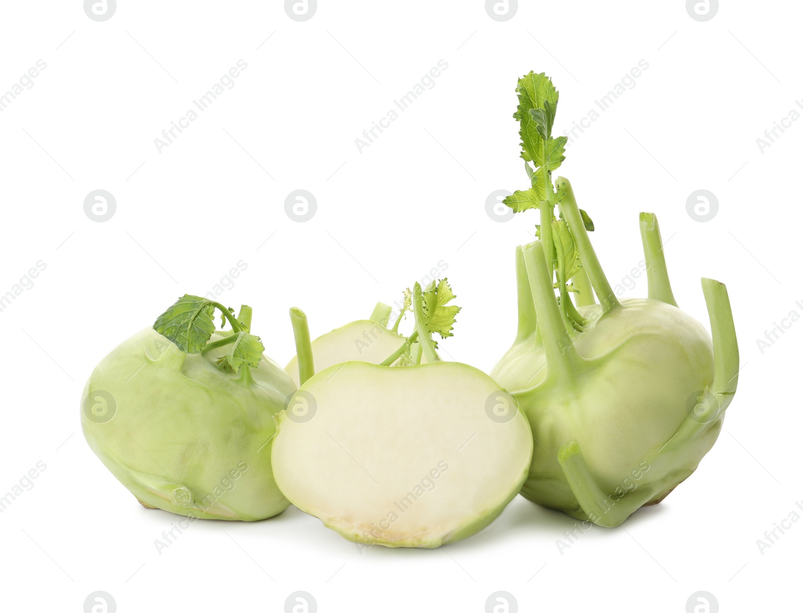 Photo of Whole and cut kohlrabi plants on white background