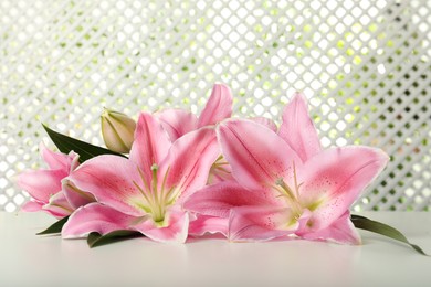 Photo of Beautiful pink lily flowers on white table