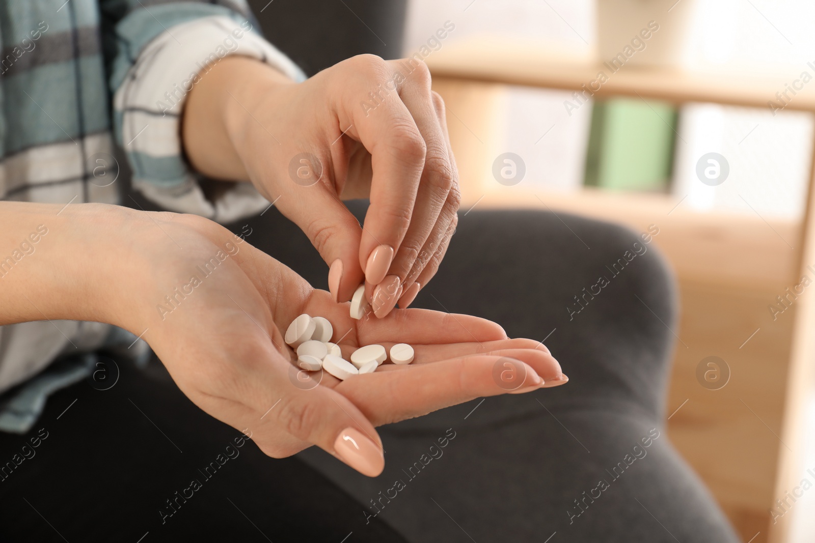 Photo of Woman taking medicine indoors, closeup view. Health care