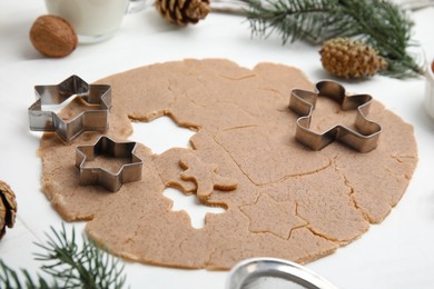 Homemade Christmas biscuits. Raw dough and cookie cutters on white table