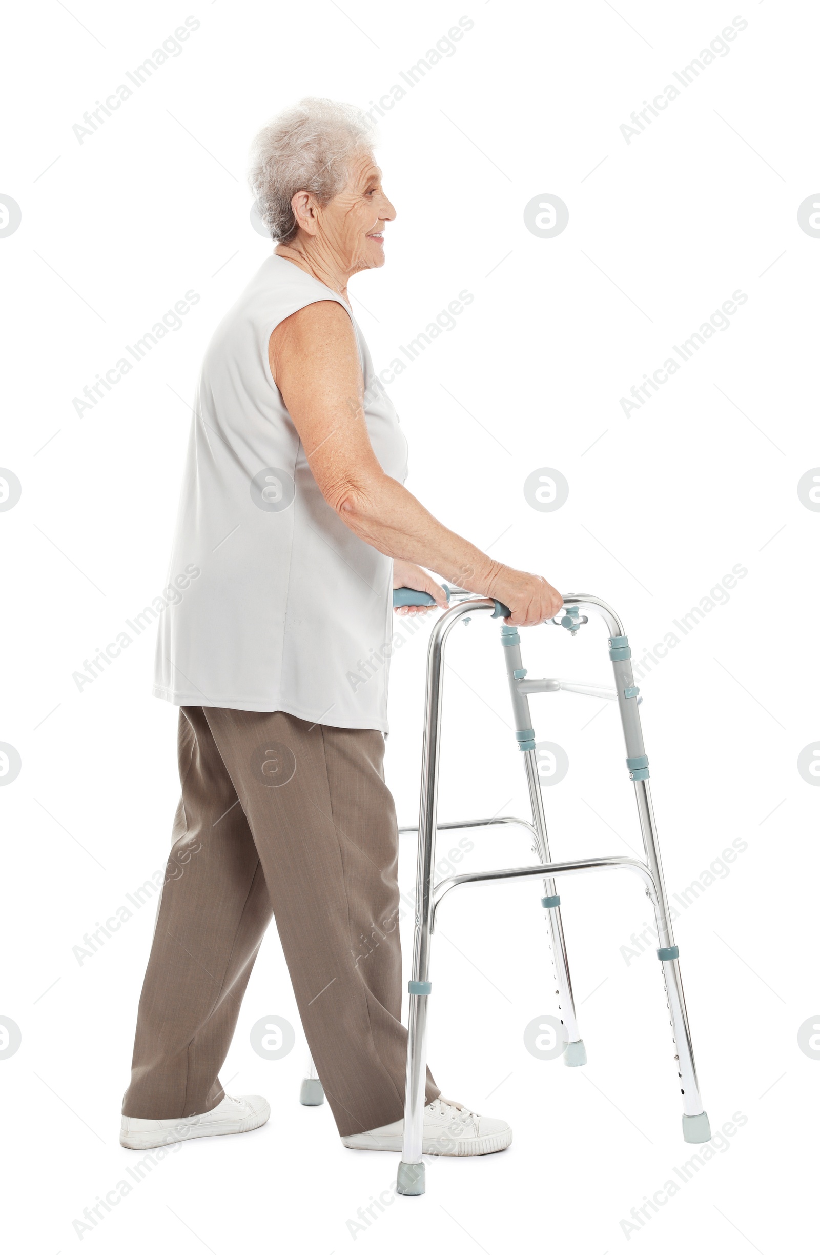 Photo of Full length portrait of elderly woman using walking frame isolated on white